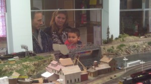 A family is watching the HO Trains at the Northern Lights Model Railroad Club in Russian Jack Springs Park.