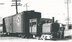 #1 (20 ton Whitcomb) with GN boxcar crossing Division Street northbound with carload of canned peas from PictSweet Cannery, 3/31/1949