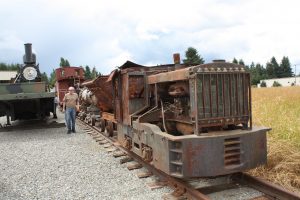 On the left is a 22 ton Shay waiting for restoration. Three foot gauge rolling stock is on the right, including D&RGW caboose #0582 and a Plymouth low cab locomotive used in mining.