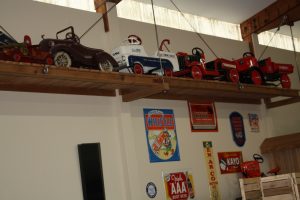 Packard convertible, GMC wrecker, Mack operating dump truck, and another red truck