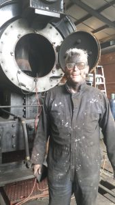 Mike Donnelly "working on the Chiggen" (by cleaning the smokebox) at the Northwest Railway Museum in Snoqualmie (Photo by Russ Segner). 